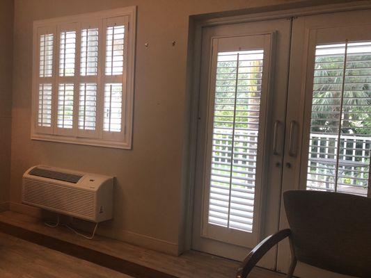 Inside room, double doors to a sitting area with table and chairs