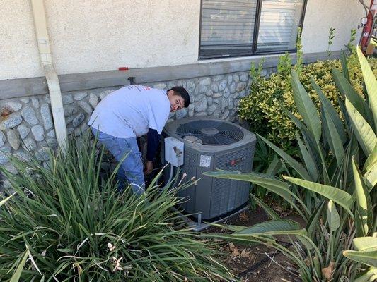 Luis installing a 14 seer trane condenser for northkirk church classroom.