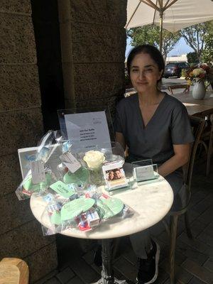 Dr. Mariam Nadi at the wild strawberry cafe enjoying the weather & giving out goodie bags.