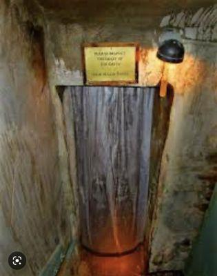 Clear disgusting bath curtain hanging before the entrance of the caves