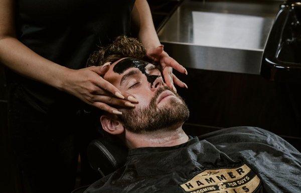 Face massage and black mask during a Premium Beard Grooming