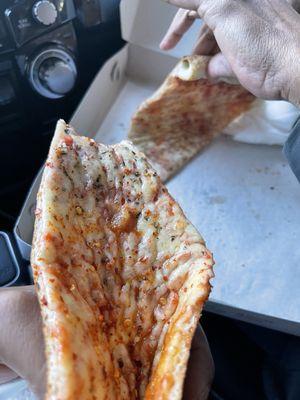 Large cheese pizza slice. I took a bite couldn't help myself..