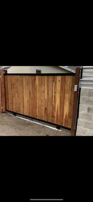 New installation,Sliding gate , redwood and iron frame combination, with solar sliding gate operator Los Angeles.