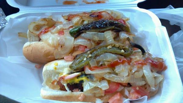 Acapulco style Hotdog .Tomatoes,  Grilled and Raw onions, Jalapeno and Relleno peppers, Mayo, Mustard, rapped in BACON!