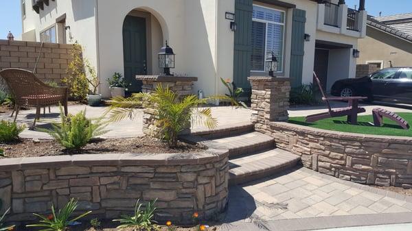 Pavers, bullnose steps, artificial turf, retaining walls, pilasters and stone veneer by Genesis Stoneworks