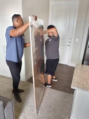 Jose And Alex Wrapping The Glass Top From One Executive Desk.