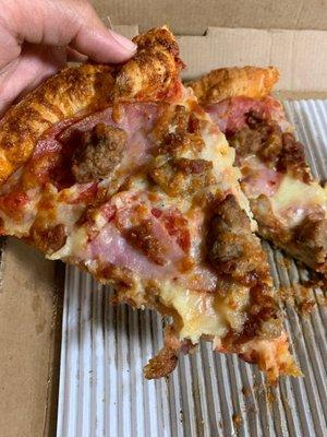 This is a meat lovers/3 meat pizza with pepperoni, big sausages and ham