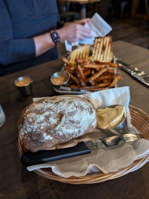 Artisanal bread with honey butter and chicken pesto panin