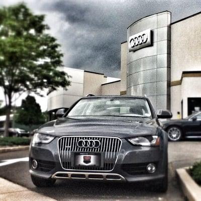 An Audi allroad sets in front of the Prestige Audi Showroom