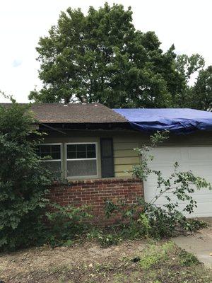 Torn edge of roof left exposed.