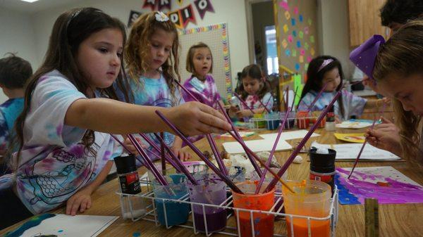 Art camps combine age-appropriate activities in art, band, dance, music technology, strings, and voice.