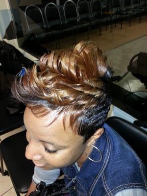 Pixie cut with a flare of permanent color.