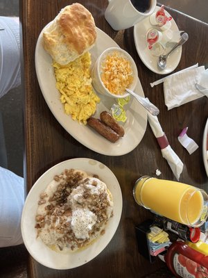 Eggs, sausage links, cheese grits, biscuits and gravy with an orange juice!