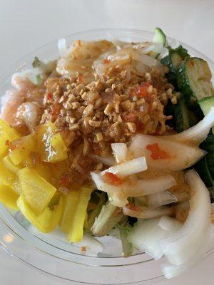 Poke bowl with spicy crab & shrimp with pickled radish, cucumbers, onions and daikon radish. Topped with fried garlic & mango chili sauce.