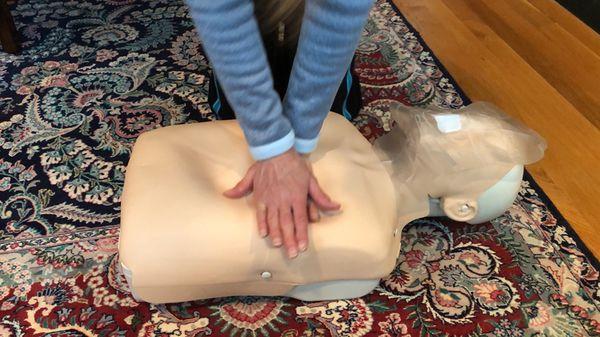 An at home training client learning to give proper compressions.