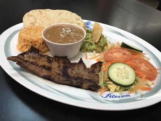 Steak with yellow rice and a side salad