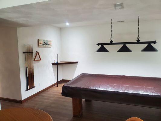 Finished pics of pool table room. Framed walls and plastered finish. Flooring installed throughout and trimmed.