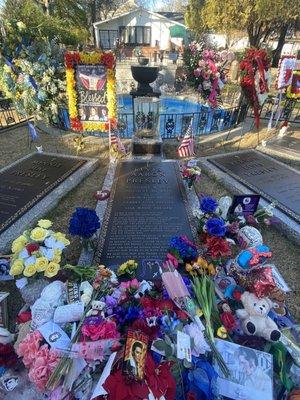 Adorning fans leave flowers and mementos at the grave.