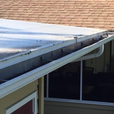 This rolled roofing is bubbling up near the gutter allowing water in.