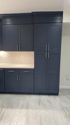 Quartz countertop, backsplash and all wood cabinets.