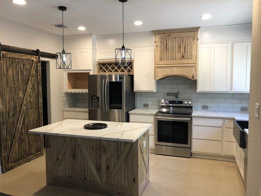 Our dream kitchen with wood tones and barn doors !