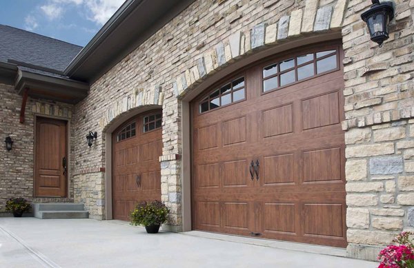 Wood look garage doors look great without the cost and maintenance of heavy cedar doors