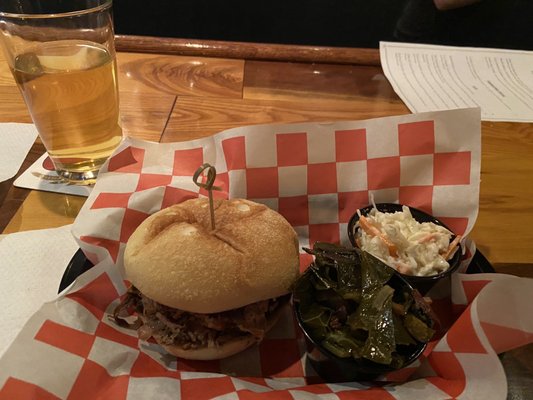 Pulled pork sandwich with coleslaw and collard greens