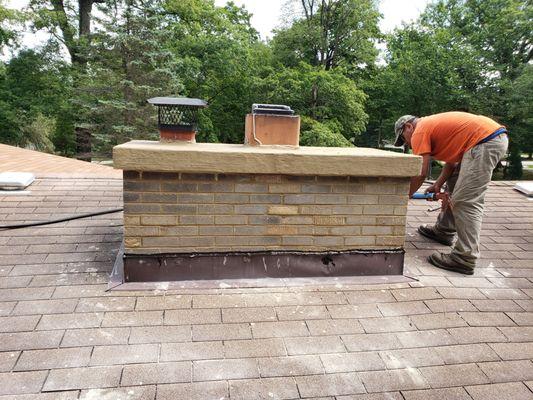 after replacing bricks, grind and tuckpoint entire chimney, recoating chimney cap .