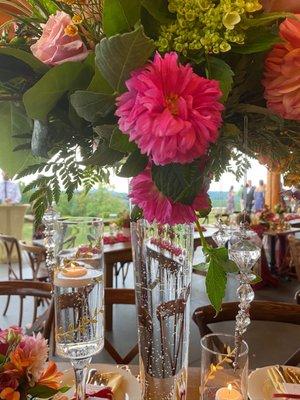 The use of tall glass vases filled with pops of color & added crystals.