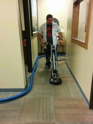 Working with the Rotovac 360i during a commercial carpet cleaning.