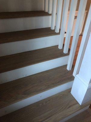 White oak floors. Did a great job around the stairs!