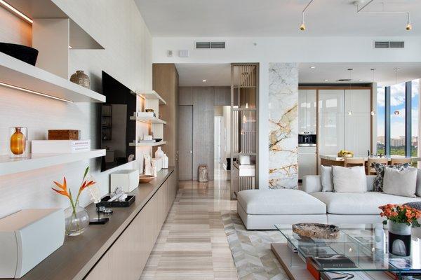 Livingroom and entertainment center flanked by marble accents