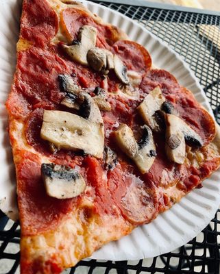 Pepperoni and mushroom pizza slice