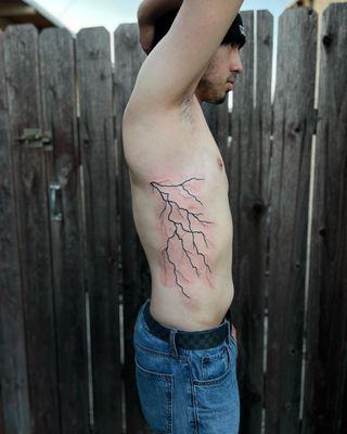 Lightening bolts on the side of clients ribs.