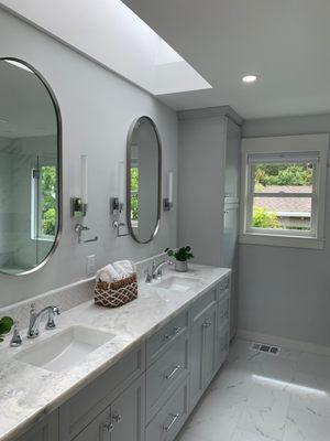 Custom primary bathroom vanity with floor length linen cabinet at end. Lots of deep drawers.