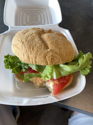 Fish sandwich w lettuce, tomato, tartar sauce  (couldn't wait to eat a piece)