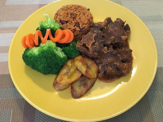 Stewed Oxtail with Pigeon Peas Seasoned Rice, sauteed broccoli and fried sweet plantains