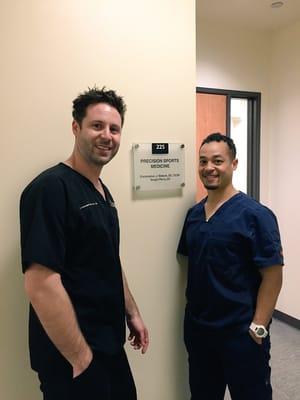 Dr. Matock & Dr. Perry in front of our new Precision Sports Medicine sign at 355 Lennon Lane Ste 225