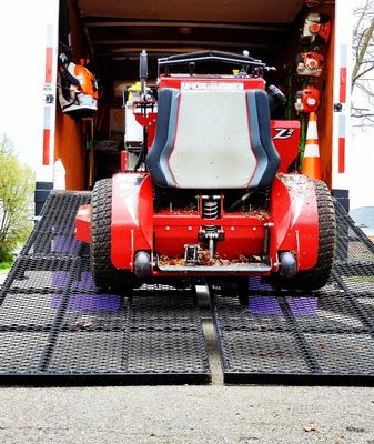 Lawn mowing truck loading up to cut grass.