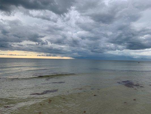 Offshore storm viewed from Naples beach at pier