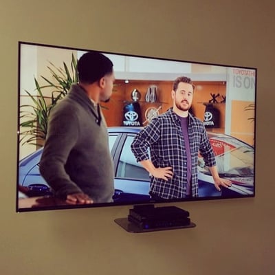 Living Room Solution -Mounted 75" television on articulating mount -Hidden Wiring  -Floating shelf installation