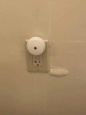 Water spreading over electrical socket.