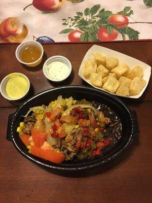 Tropichop bowl with the Mojo pork, yellow rice and black beans and all the toppings. Fried yucca and dipping sauces.