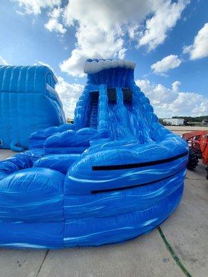 Plunge into excitement with the 18ft Monster Wave Slide Rental! This imposing water slide rocks deep blue walls and is remini...