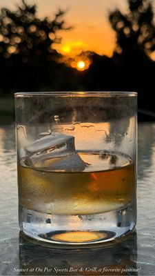 Johny Red on the patio, view of the sunset and golf course.