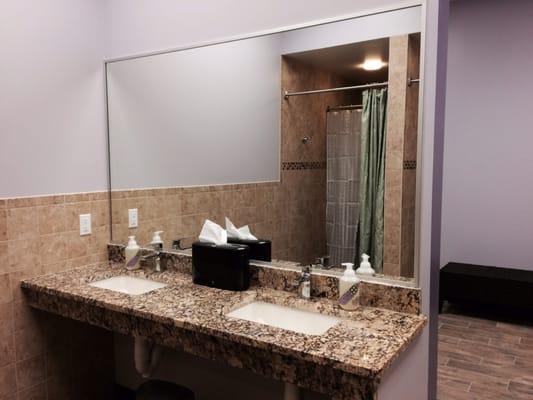 Granite counter top sinks in shower area.