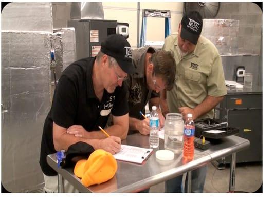 Students "gathering the numbers" in the Total Tech HVAC lab.