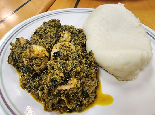 Shrimp egusi with yam (cassava) fufu to scoop it up with. My fave.