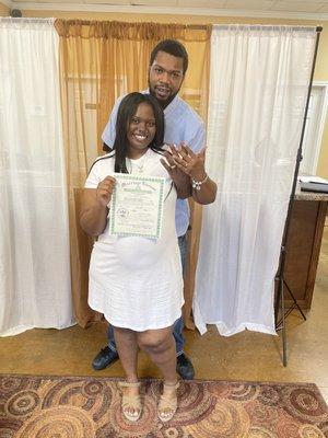 Beautiful couple with their marriage license