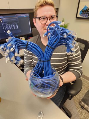 Our operations manager holding a bouquet of cat 5E cables on Valentine's Day